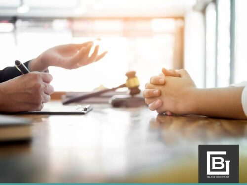 A client consults with a bankruptcy lawyer, with a gavel suggesting a legal setting