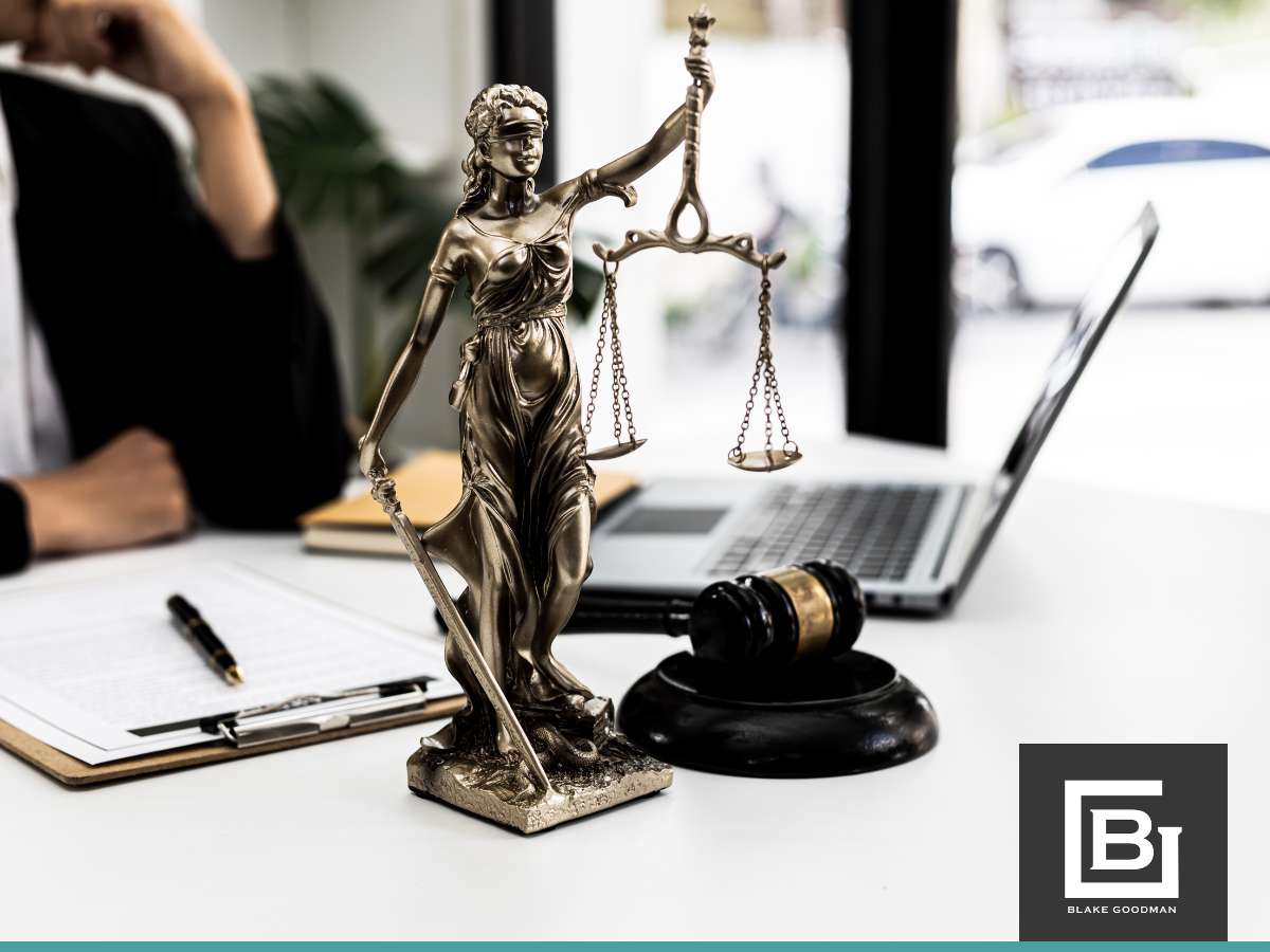Lady Justice statue and gavel on a lawyer's desk with the logo of a Hawaiian bankruptcy attorney in the foreground.