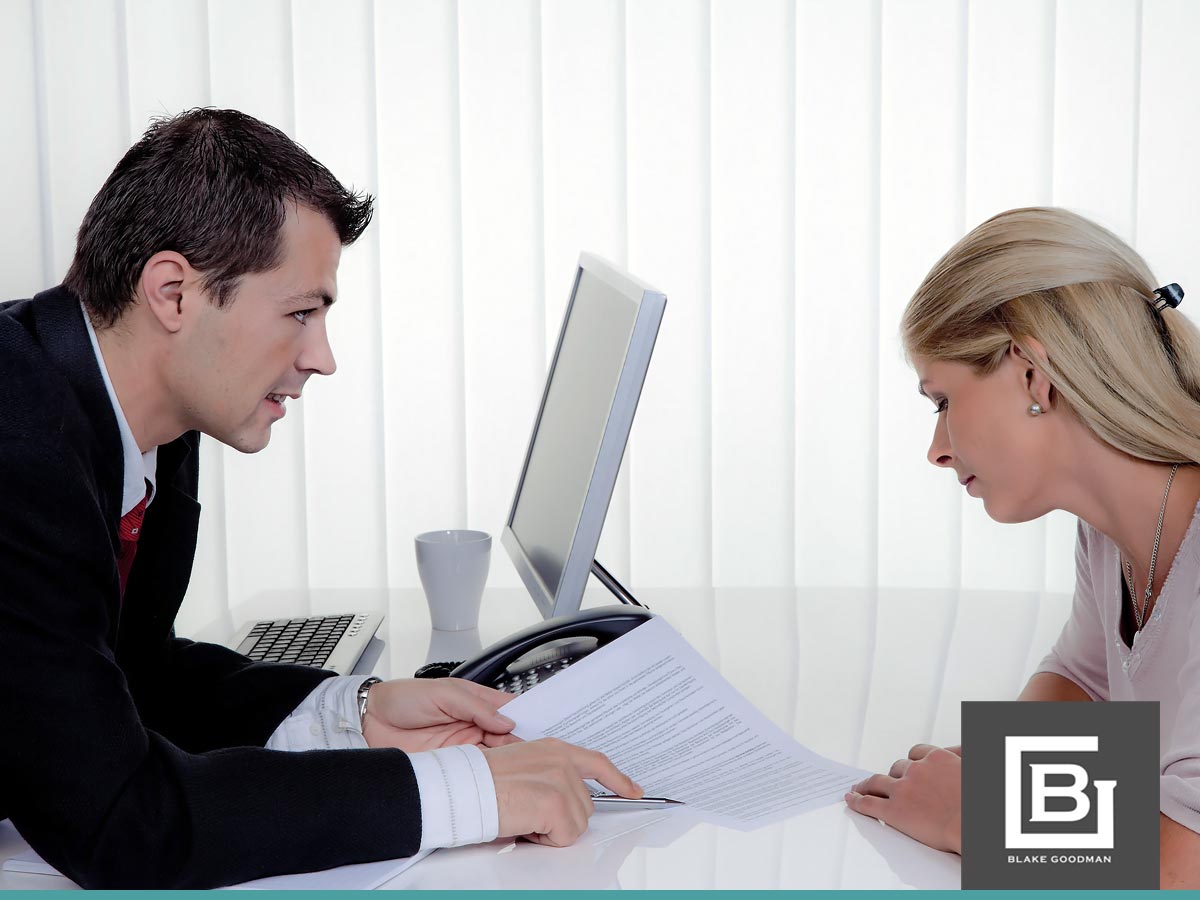 A bankruptcy attorney discusses paperwork with a client during a consultation, emphasizing the bankruptcy process